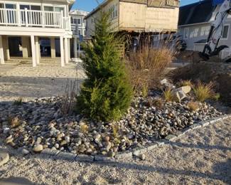 River rocks; grasses; shrubs; Belgian blocks