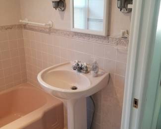 Pedestal sink; mirrored medicine cabinet; vanity lights