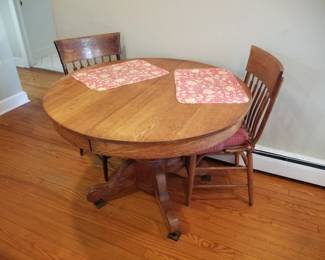 Oak pedestal table with 4 chairs (two shown - four available)
