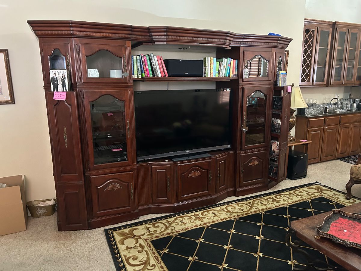 Lovely large entertainment center with books, CD's and DVD's with Stereo equipment and speakers with woofer