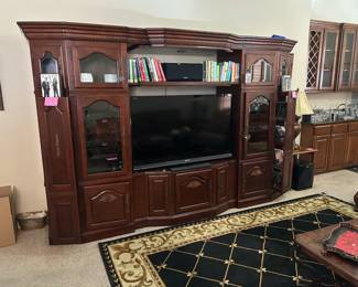 Lovely large entertainment center with books, CD's and DVD's with Stereo equipment and speakers with woofer