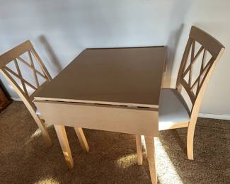 New drop leaf table and two chairs never used