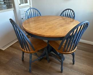 A view of the top of the round table with four chairs set has an extra leaf as well