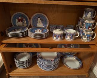 Two lower drawers of lawyer stacking bookcase shown open with Christmas dishes set