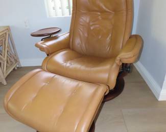 Two matching leather pushback recliners with footstools.