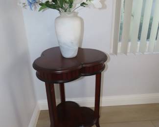 Cherry colored shamrock shaped end table.