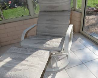 Two swivel sun chairs with foot stools.