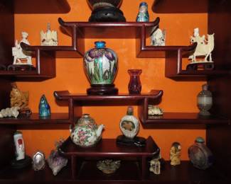 Rosewood Asian wall curio with bone like pieces, Netsukes, miniatures.