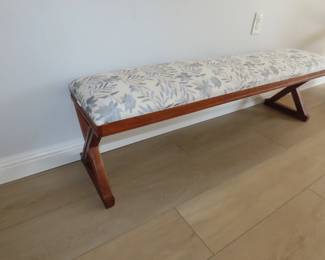 Long narrow padded bench.