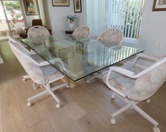 Glass dining table with brass and faux marble pedestal with 6 chairs.