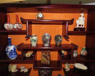 Rosewood Asian wall curio with bone like pieces, Netsukes, miniatures.