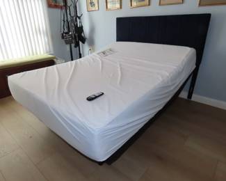 Like new adjustable queen size bed with beautiful blue headboard.