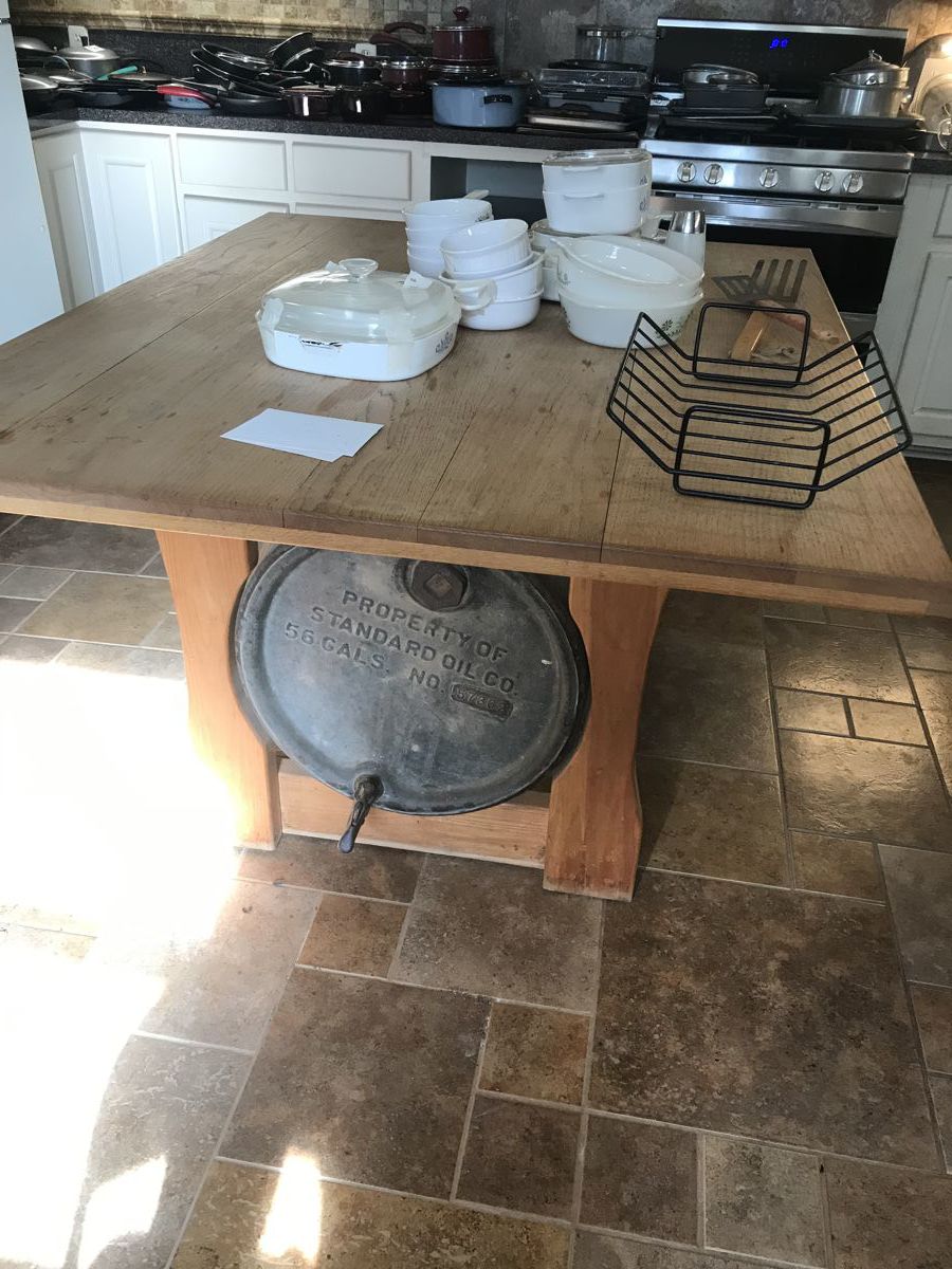 Solid wood table with antique barrel for base. 