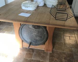 Solid wood table with antique barrel for base.
