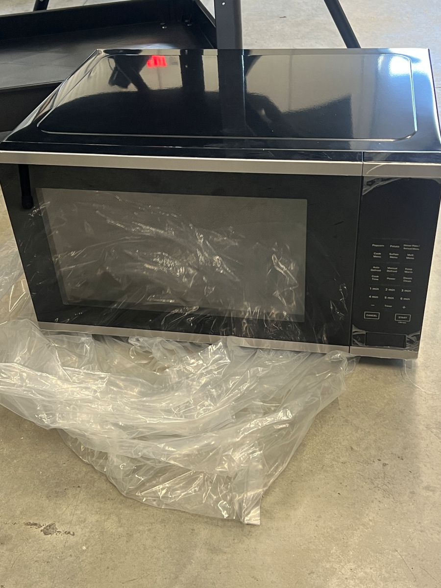 New - modern black microwave oven - $99 