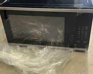 New - modern black microwave oven - $99