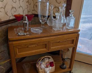 Contemporary bar cart, crystal decanters, crystal dispenser, martini glasses, etc.
