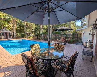 Cute wrought-iron outdoor bistro table and chairs with umbrella 