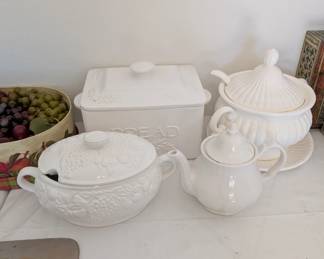 White ceramic serving dishes - bread box, soup tureen, sauce tureen and small teapot 
