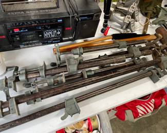 Table full of bar clamps 