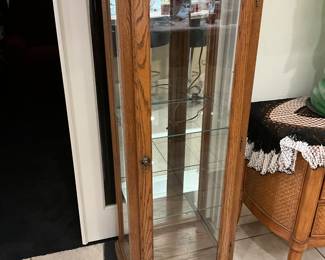 A wooden oak curio cabinet with glass doors and shelves. estimate this oak curio cabinet to be valued between $100-$300 USD. Sale price $75