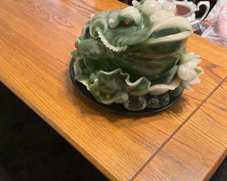 A decorative green stone frog sculpture with lotus flowers. estimate this decorative frog sculpture to be valued between $100-$250 USD. Sale price $50
