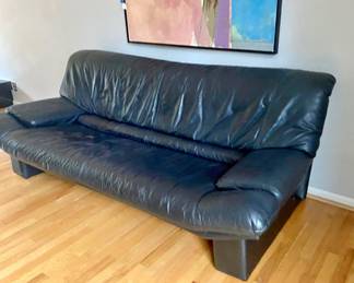 Matching pair of sleek, black leather sofas