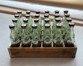 Miniature set of glass Coca-Cola bottles in a wood crate