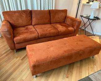 Orange upholstered sofa and large ottoman