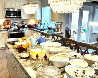 Kitchen is filled with cookware, serving platters, bowls, Pyrex, you name it.