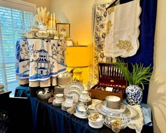 LINENS AND CHINA EVERYWHERE. POP IN SOME BLUE AND WHITE.