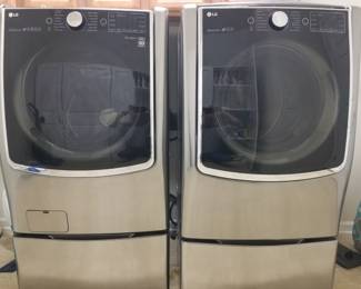 LG washer and dryer with bases. 