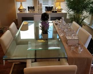 Contemporary glass top dining table with six chairs.  