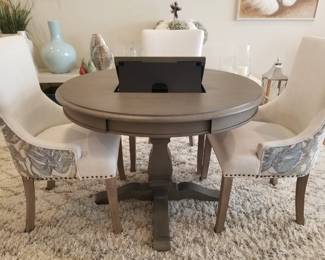 Round breakfast table with computer pad built-in easel and charging station with R.K. dining chairs. 