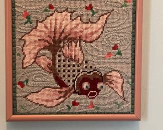 Several framed embroidered art pieces and embroidered pillows