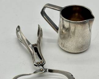 Vintage Hotel Astoria creamer and lettuce tongs.