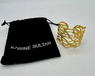 Gold toned cuff bracelet by Karine Sultan.