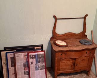 Downstairs Blue Room
Framed newspaper obituaries of celebrities 
Commode