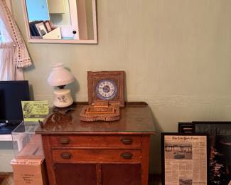 Downstairs Blue Room 
Commode
Newspaper articles framed
