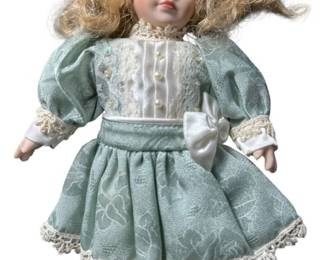 Porcelain Doll With Bow And A Dress 