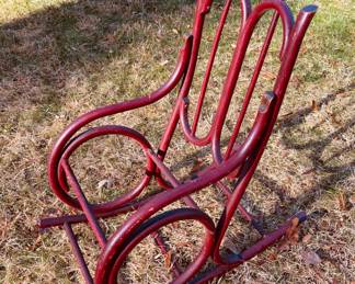 Antique child's bentwood rocker with traces of painted decoration...