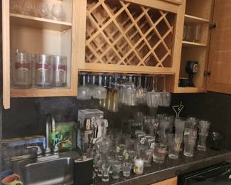 collection of glassware, mostly beer, wine, cocktail, and shot glasses