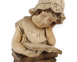 A Vintage Plaster Sculpture of a Girl Reading on a Stack of Books