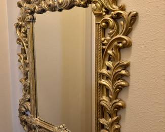 Vintage Baroque style gilt mirror with an ornate floral scroll frame