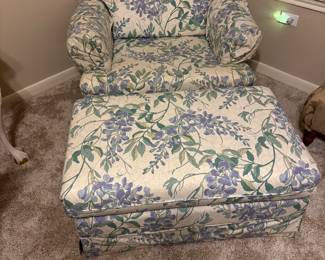 Vintage floral upholstered armchair with a matching ottoman