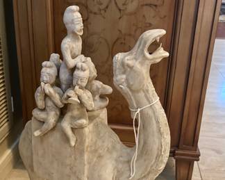 Reproduction of a Tang Dynasty figure depicting a Bactrian camel carrying a group of musicians or entertainers.