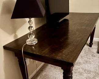 Long Table that can be used as a desk / Entertainment Center or Dining Table
Small Lucite Lamp
Flat Screen TV with Stand