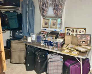 Various size suitcases & picture frames