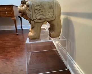 C42 - $450. Foo Dog Side Table. Glass top with lucite bases. Measures 66" x 15" deep x 28.5" tall. Dogs are porcelain material. 