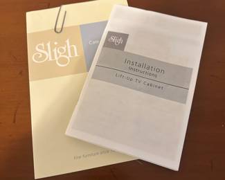 C111 - $1750. Sligh TV Lift Media Cabinet with Remote. Moves in 3 pieces. Each side piece is 24" wide x 27" deep x 34" tall. Center piece is 5' long x 28" deep x 34" tall. 